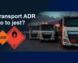 Ciężarówki z oznaczeniami ADR, symbolizujące transport ładunków niebezpiecznych.
