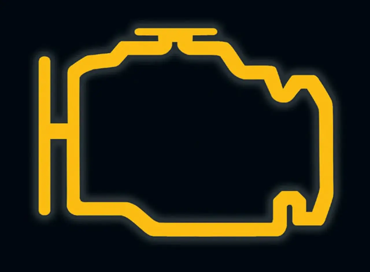 Żółty symbol silnika na ciemnym tle. Migający check engine to znak, że coś jest nie tak z samochodem.